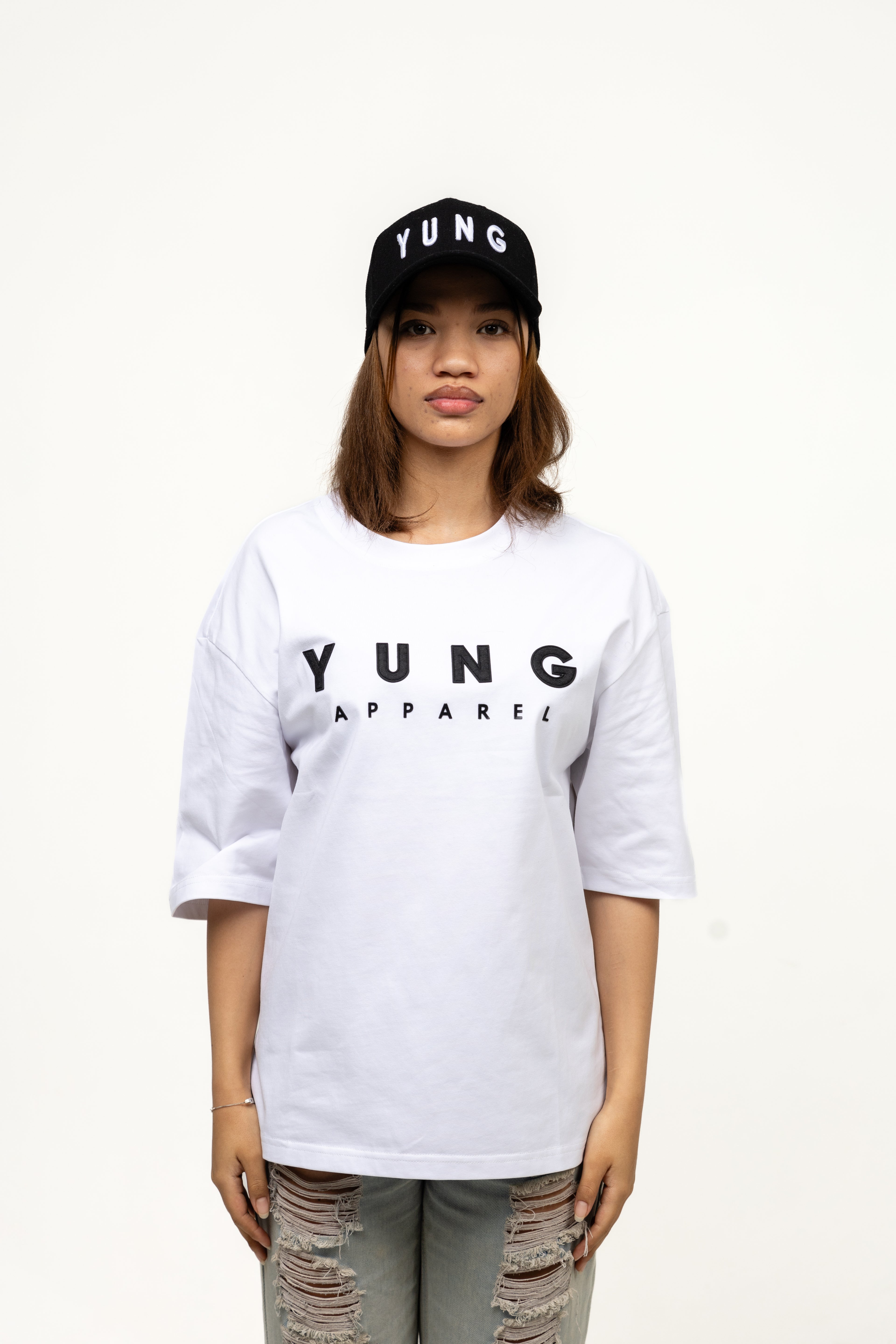 Person wearing a white 'YUNG APPAREL' t-shirt and black cap on a white background
Streetwear South Africa