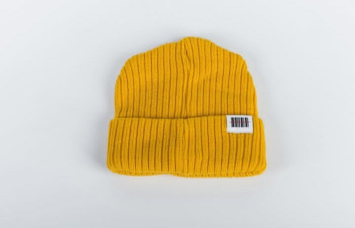 Mustard knit beanie with a label on a white background
Streetwear South Africa