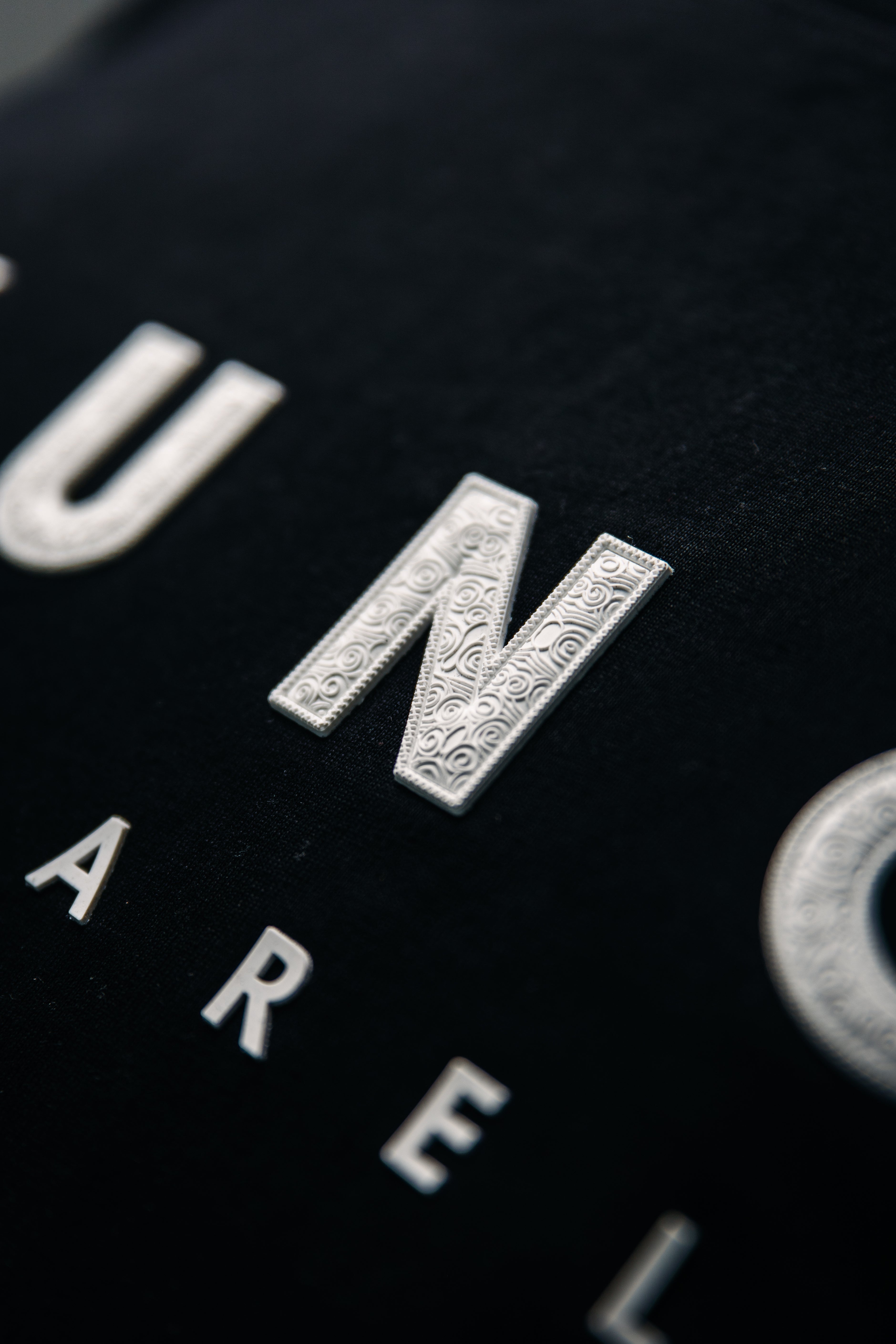 Close-up of a YUNG black garment with white text and logos.
South Africa