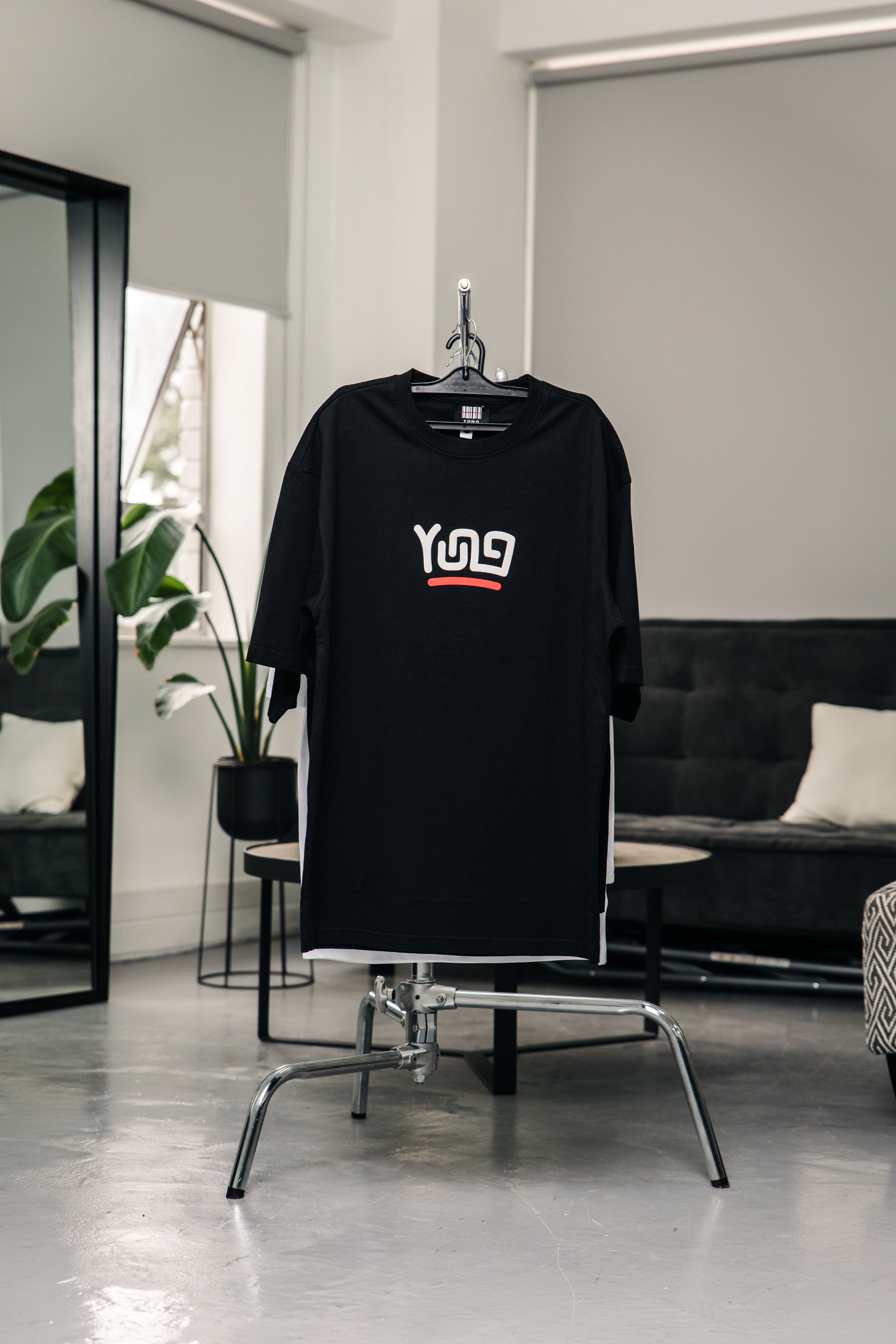 Black t-shirt with a yung logo on a chair in a modern room
Streetwear South Africa