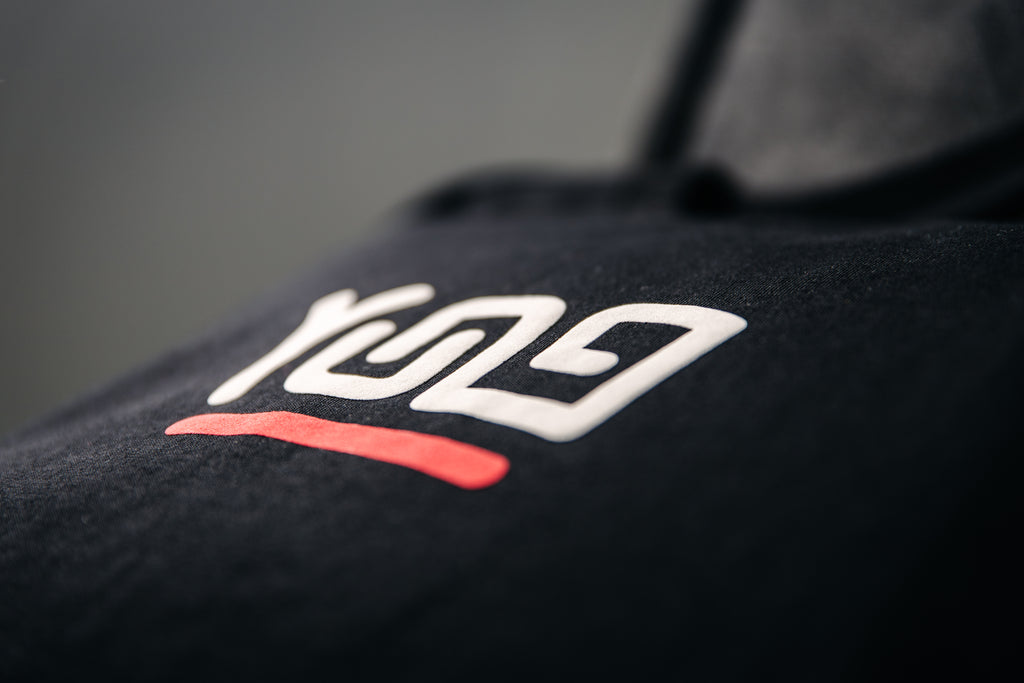 Close-up of a Y U N G black T-shirt with a logo on a gray background
Streetwear South Africa