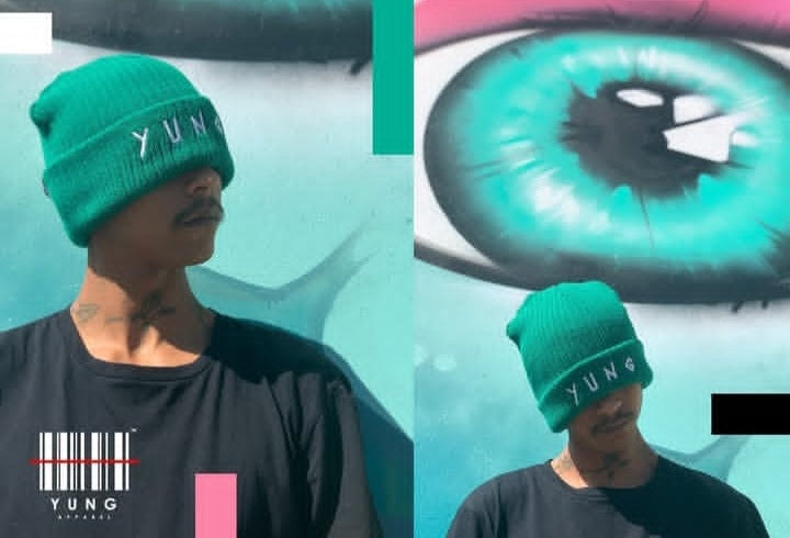 Person wearing a green beanie with 'YUNG' branding, surrounded by abstract art.
Streetwear South Africa