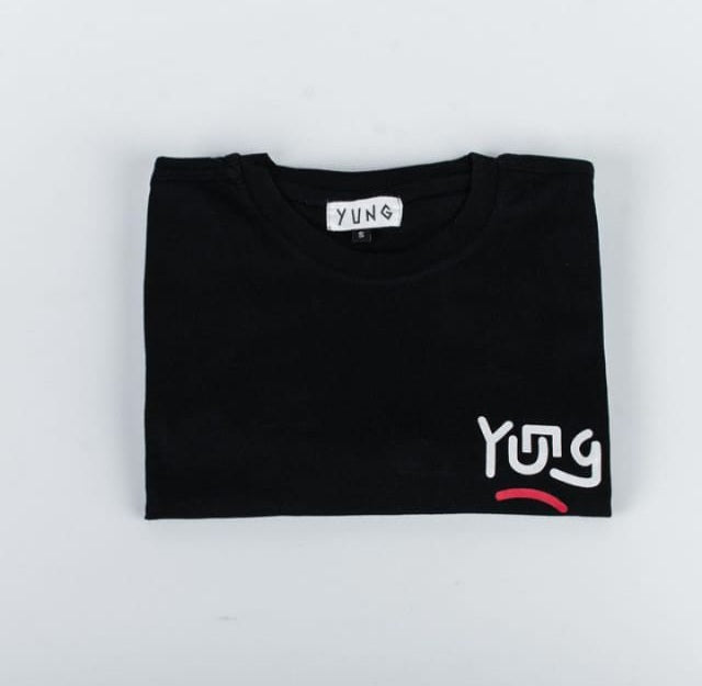 Folded black t-shirt with 'YUNG' branding on a light gray background
Streetwear South Africa