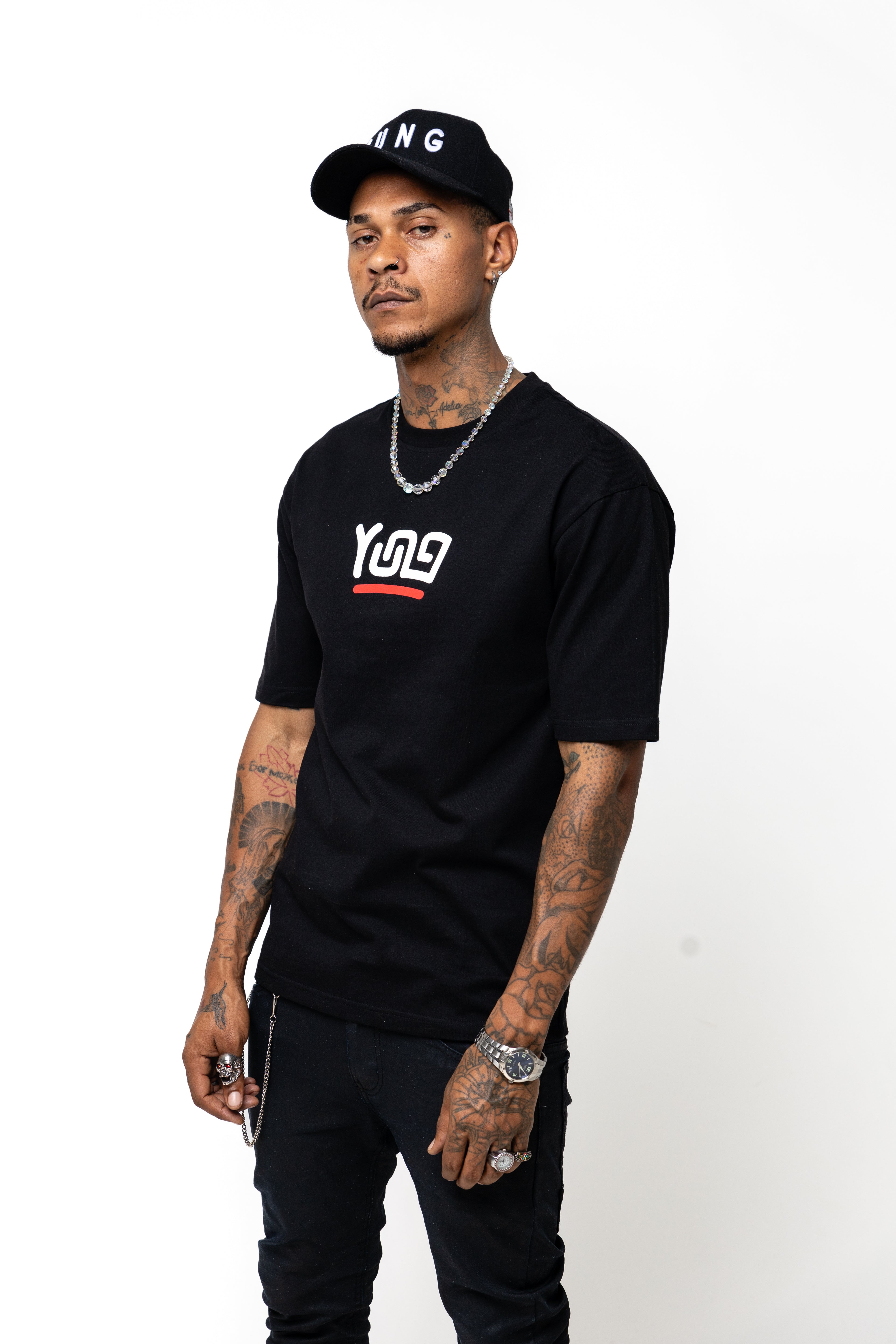 Man wearing a YUNG black t-shirt with a logo and text, standing against a white background
Streetwear South Africa