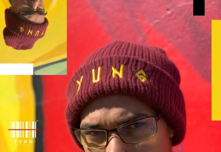 Person wearing a maroon beanie with 'YUNG' text on a red background
South Africa 