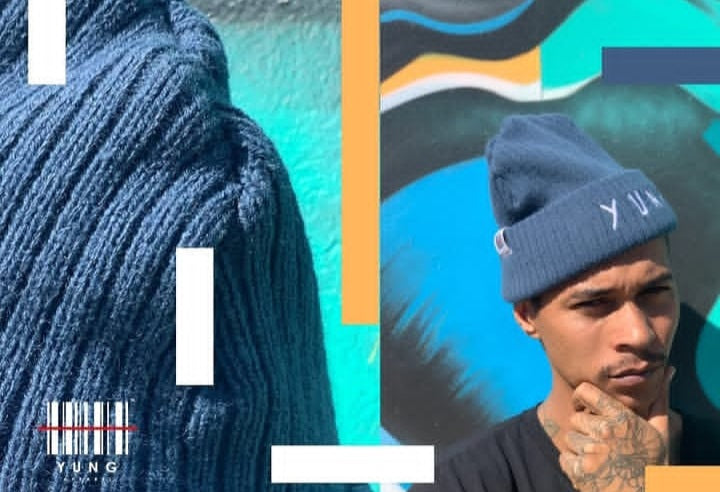 Person wearing a blue knit beanie with 'YUNG' branding against a colorful abstract background.
Streetwear South Africa
