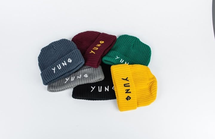 Set of colorful knit beanie hats with 'YUNG' branding on a white background
South Africa