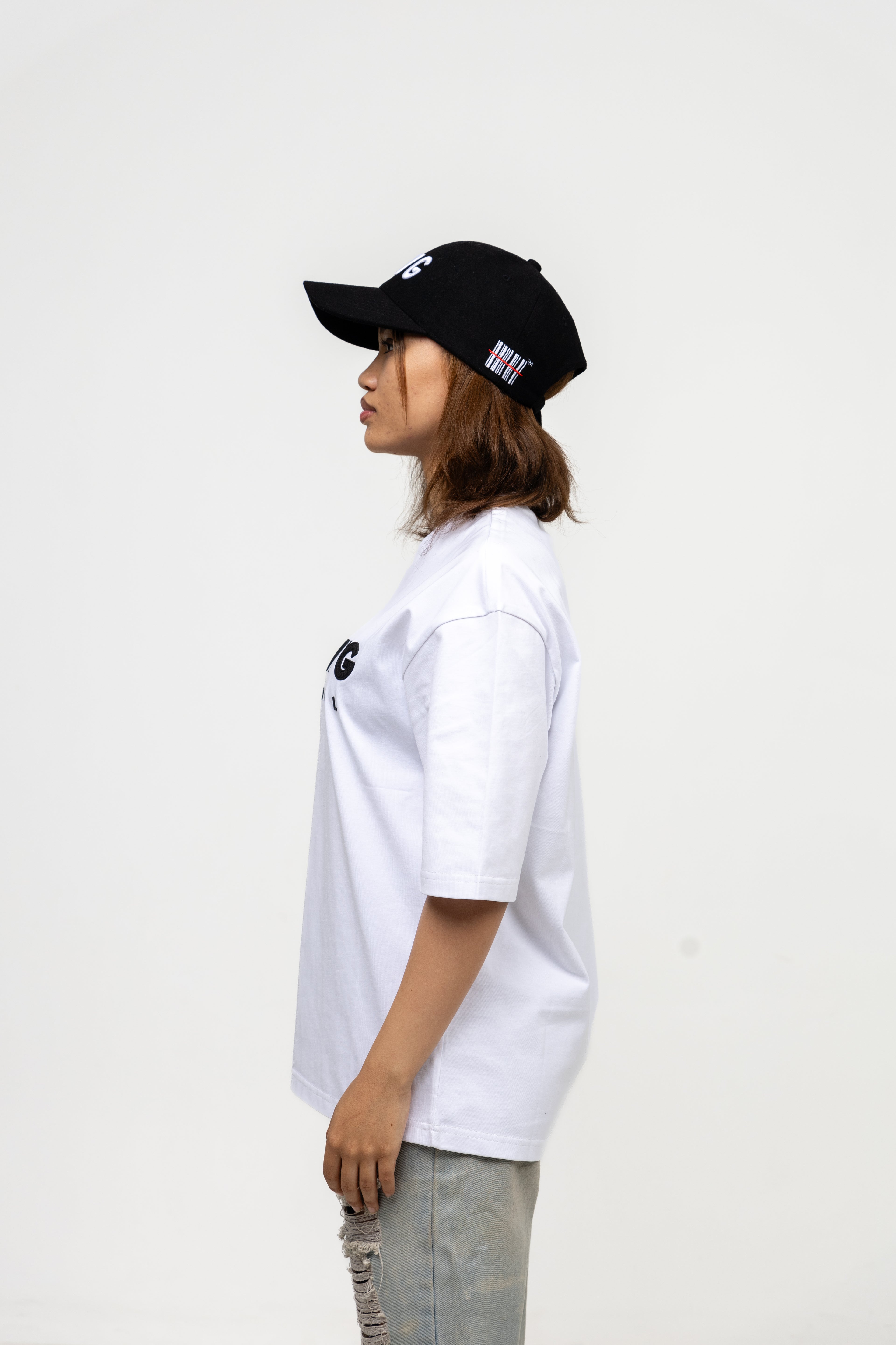 Person wearing a black cap and white t-shirt on a white background
Streetwear South Africa