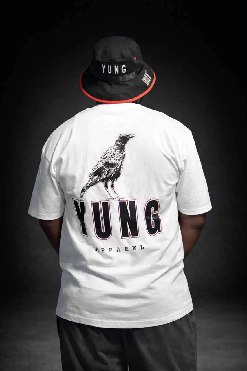 Person wearing a white t-shirt with 'YUNG' branding and a bird graphic, standing against a dark background.
South Africa