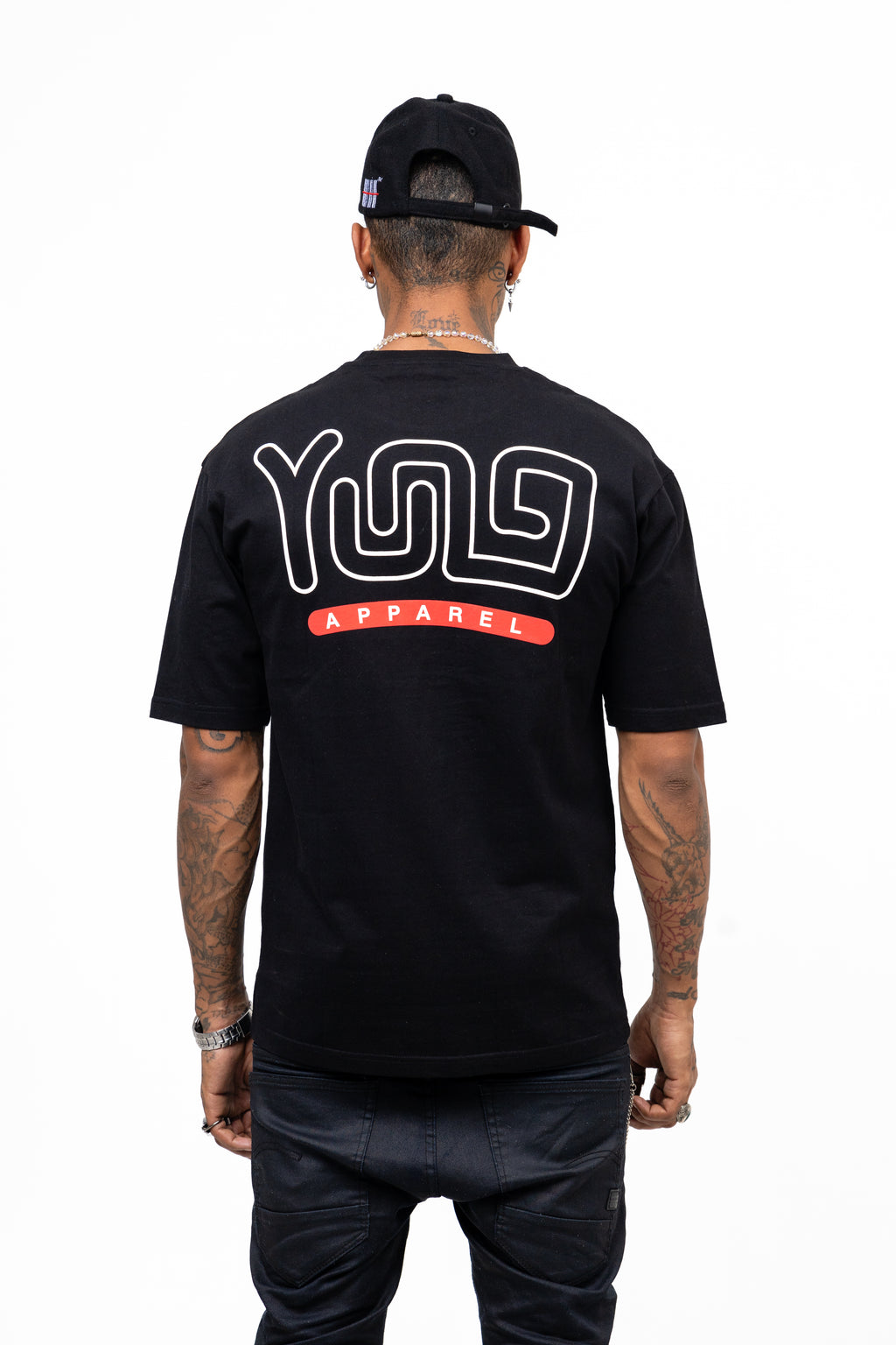 Person wearing a black t-shirt with 'YUG Apparel' logo on the back, standing against a white background.
Streetwear South Africa