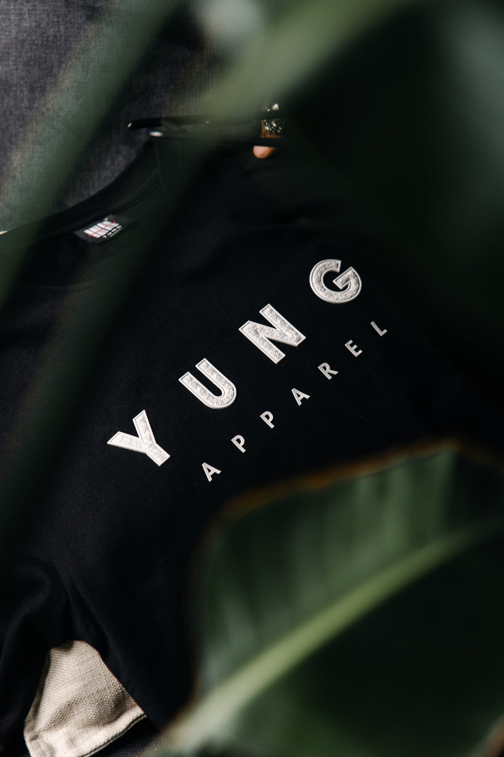 Black garment with 'YUNG APPAREL' branding on a dark background
Streetwear South Africa
