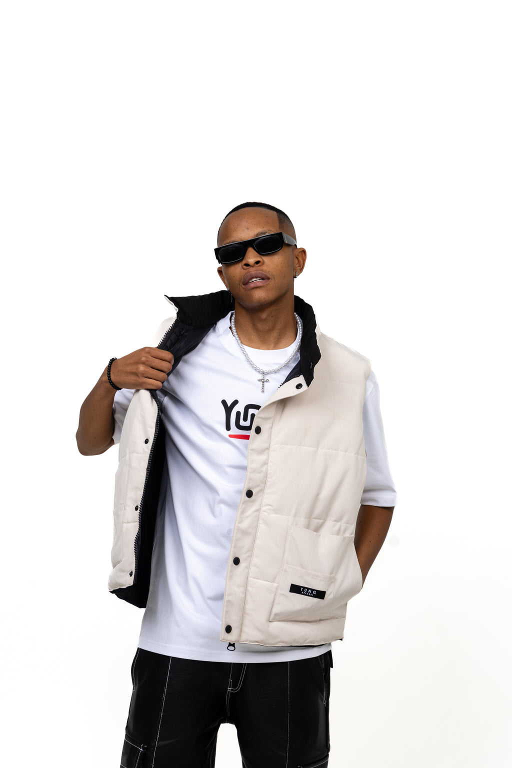 Man wearing a white puffer vest over a white t-shirt with a logo on a white background
Streetwear South Africa