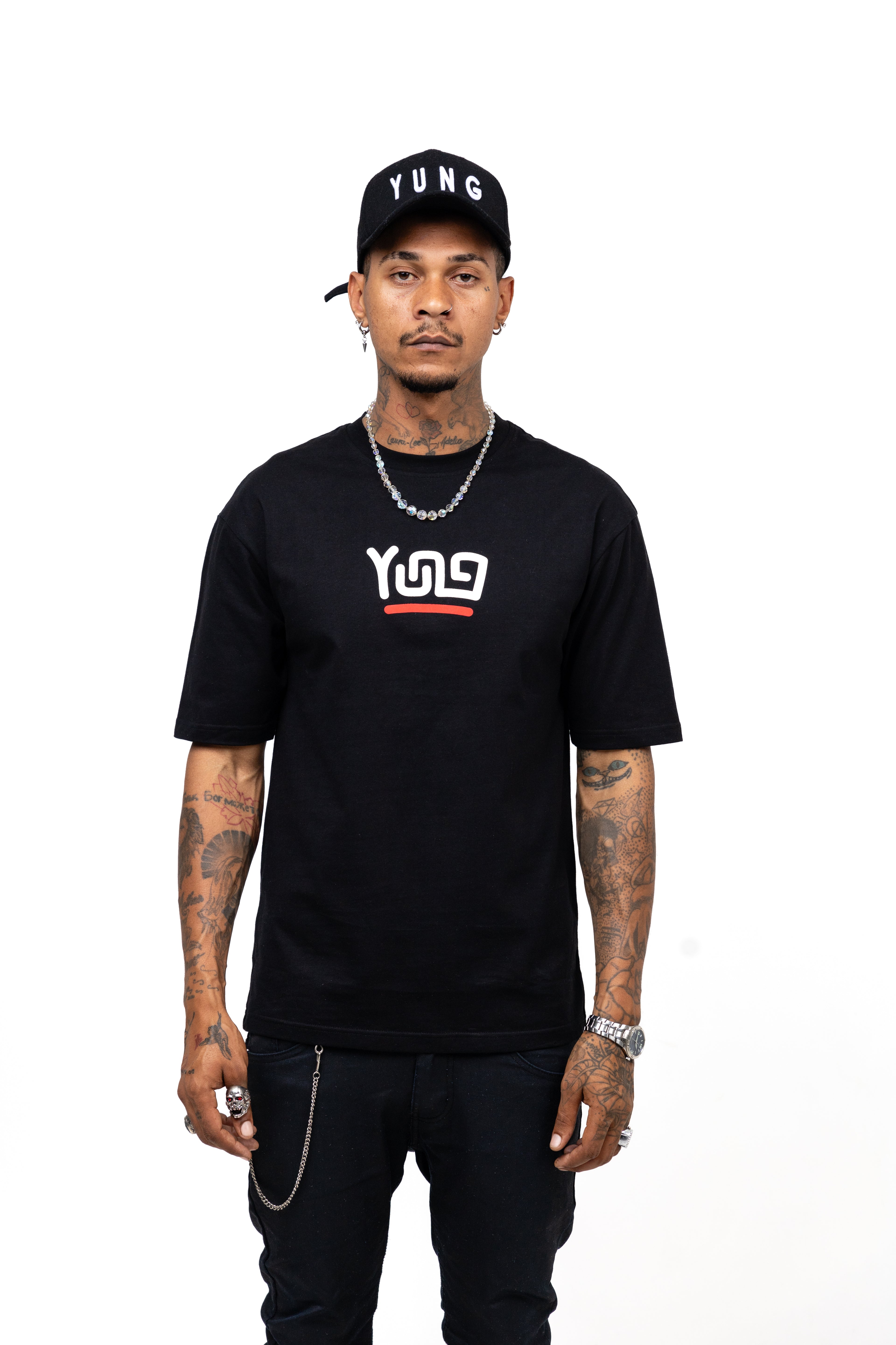 Man wearing a black t-shirt with a  Y U N Glogo and text, black pants, and a black cap with 'YUNG' on a white background.
Streetwear South Africa
