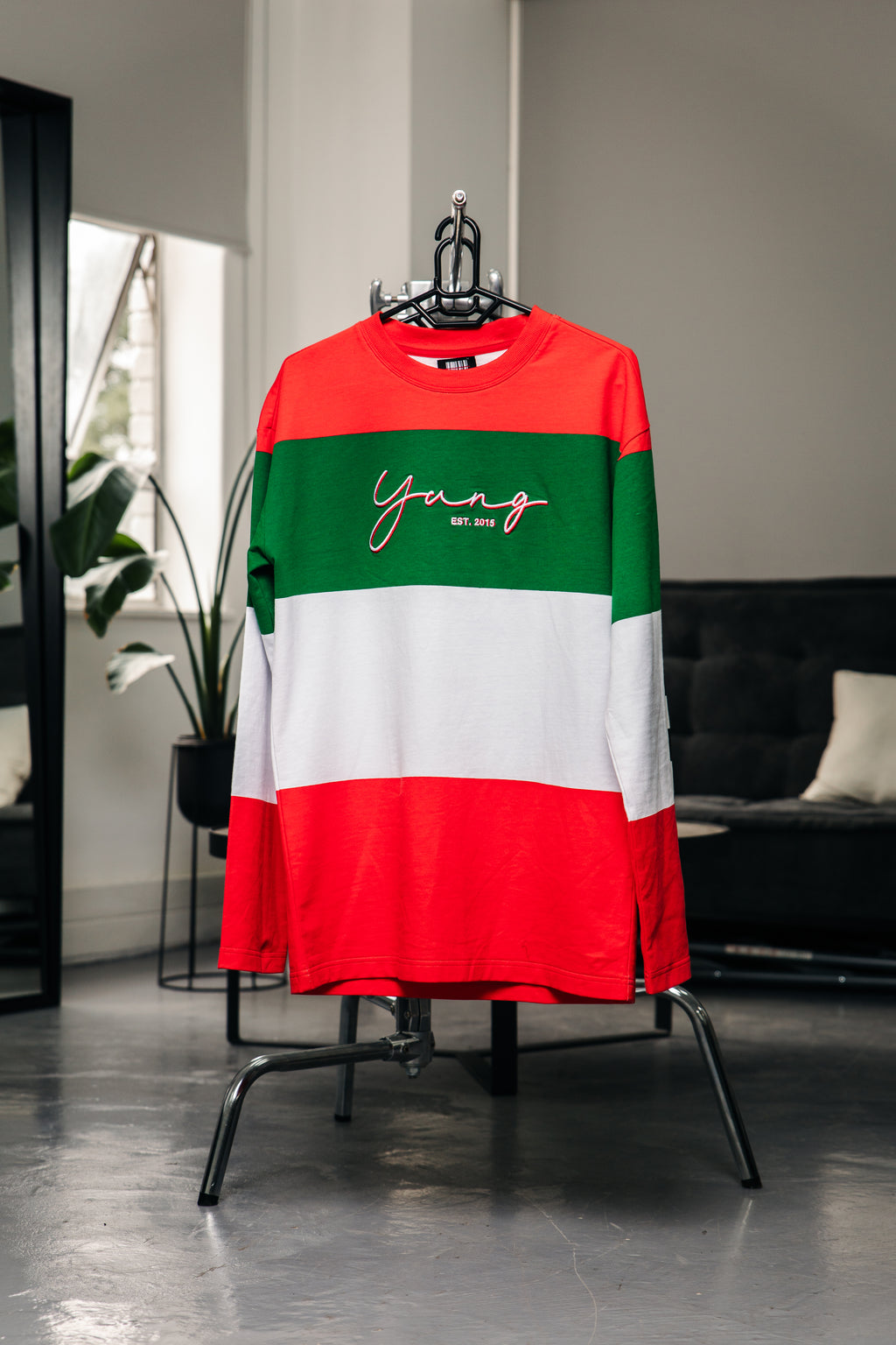 Colorful striped sweater with 'Young' text on a hanger in a room.
Streetwear South Africa