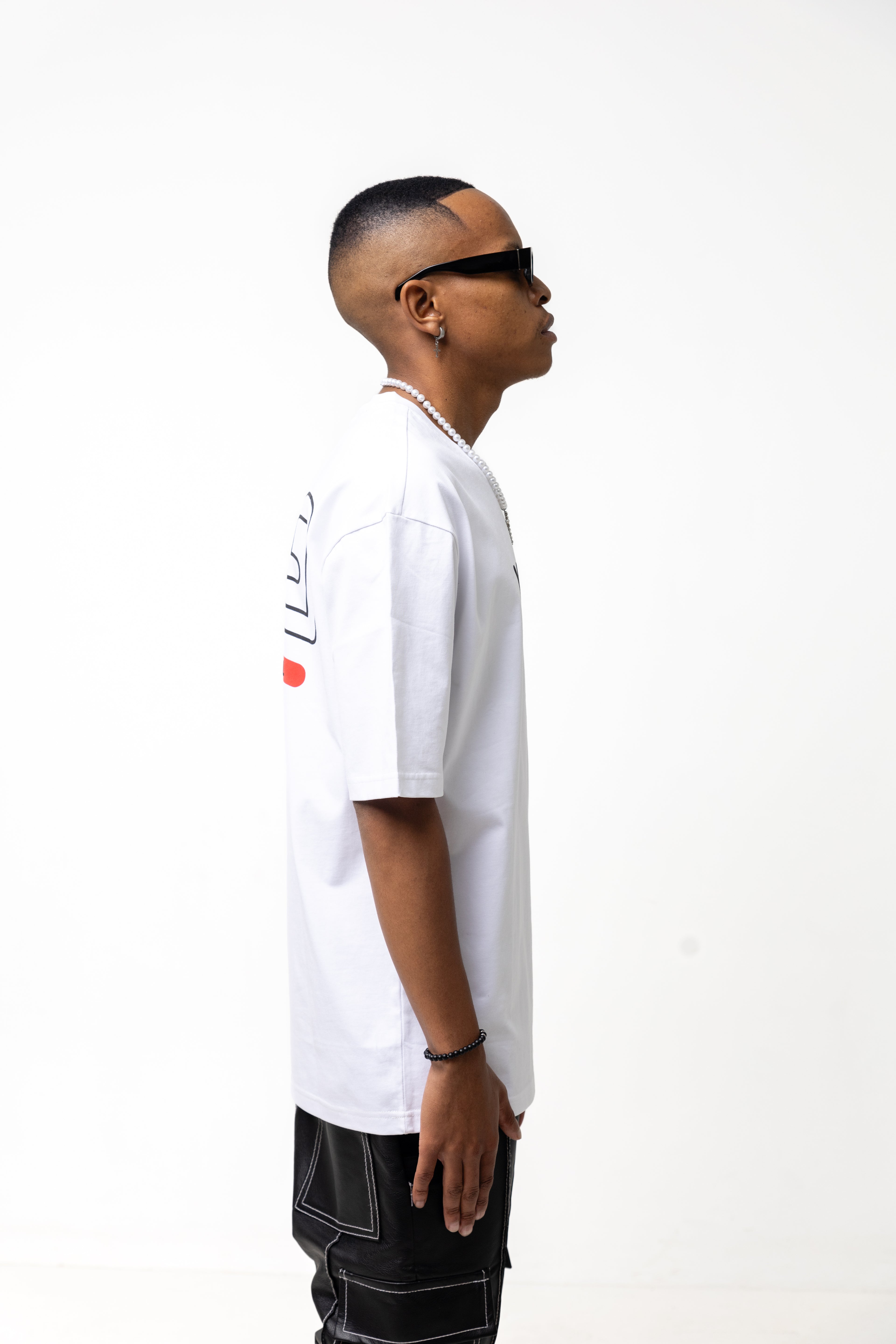 Man wearing a  Y U N Gwhite t-shirt with text and graphics on a white background
Streetwear South Africa